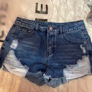 Never worn, medium dark wash ripped mini shorts